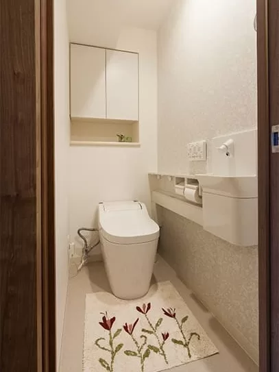 白で統一しながら大人っぽいかわいらしさのあるクロスを使ったトイレ